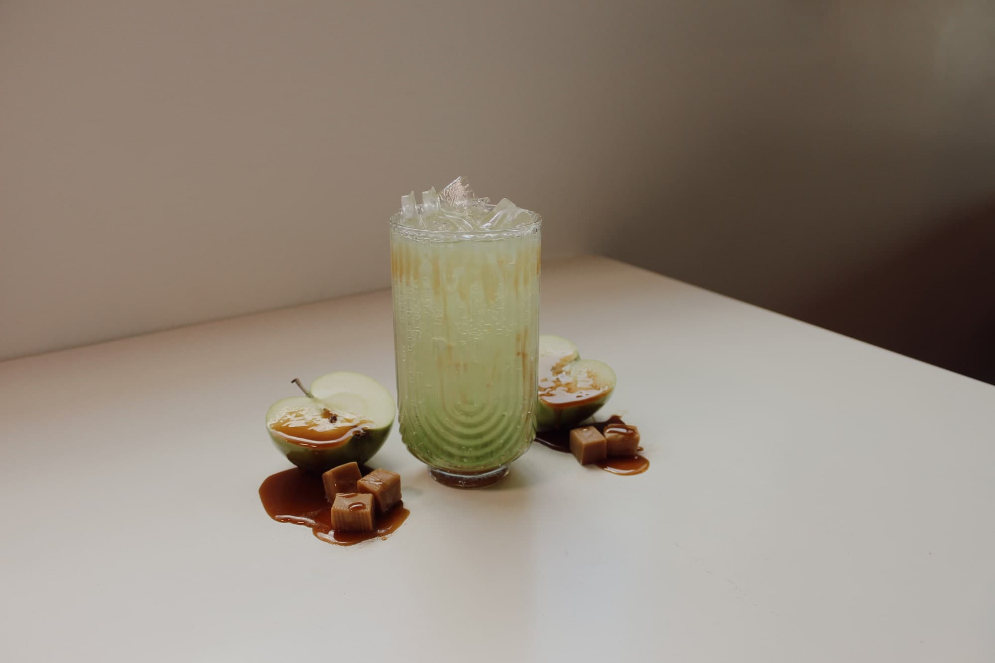 Seasonal caramel apple specialty drink with green apple garnish