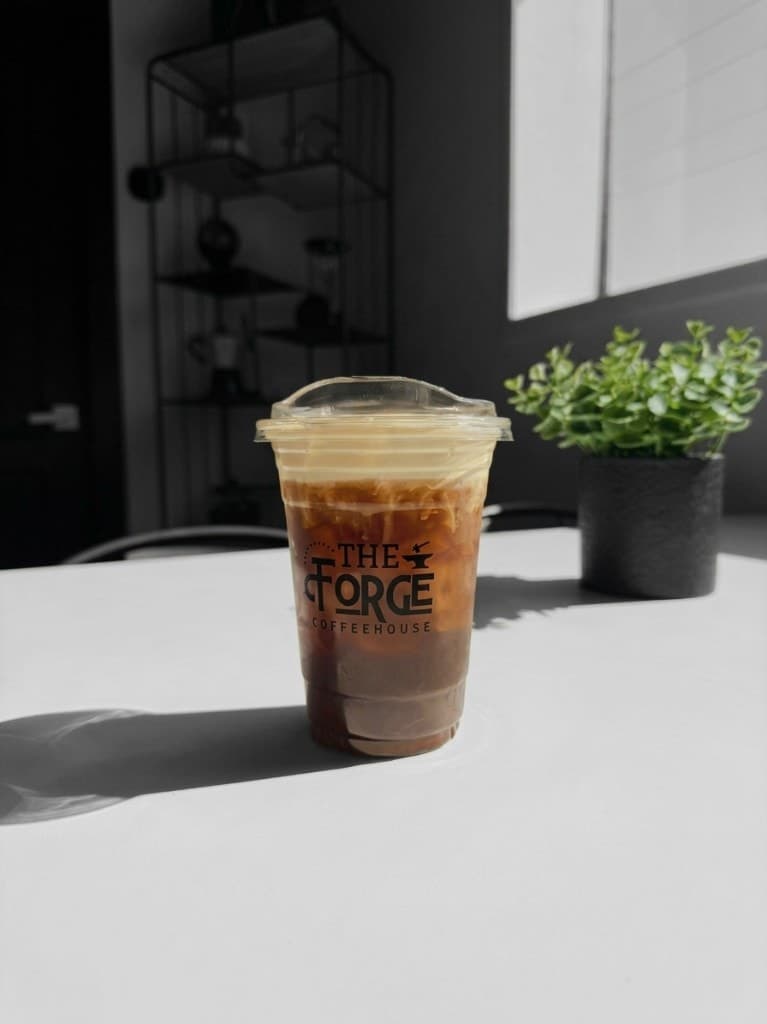 Branded Forge Coffeehouse cold brew topped with cold foam